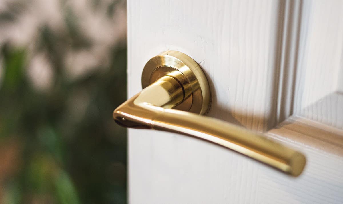 Brass door handle on rose