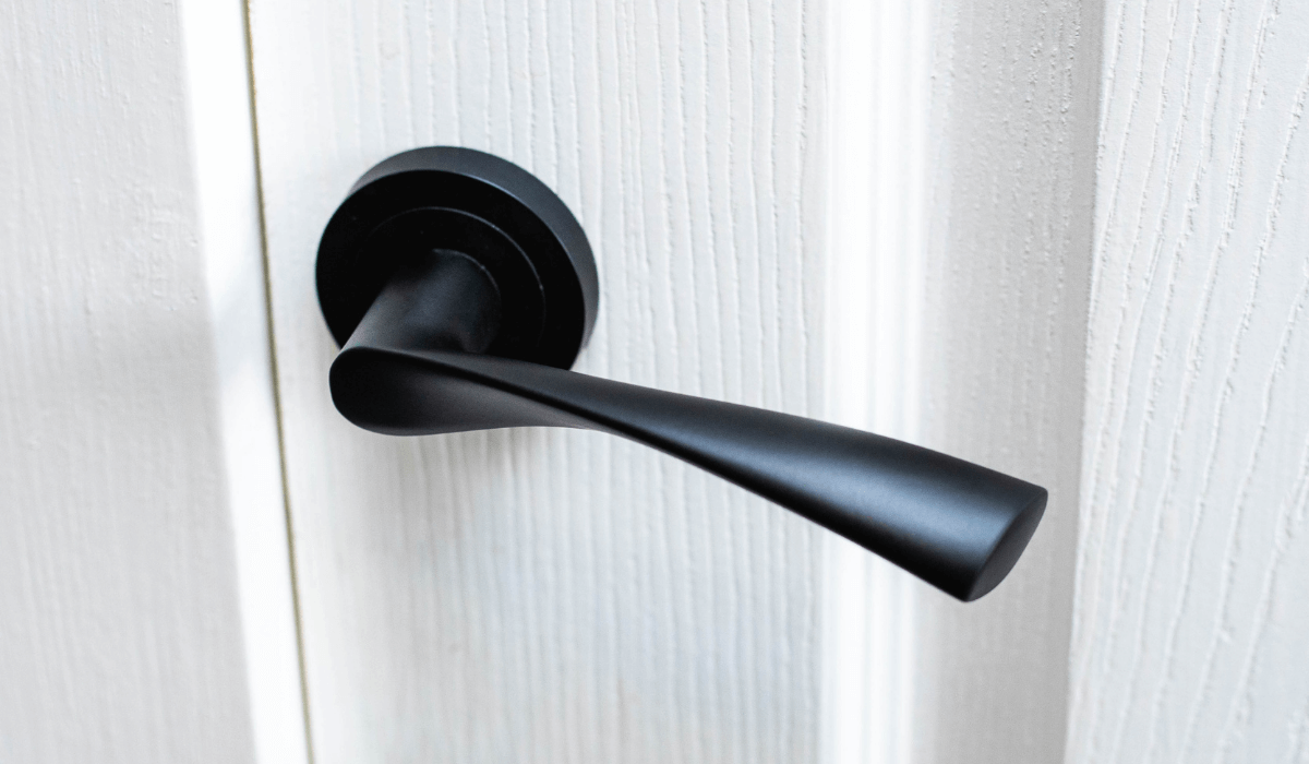 Marvel lever on rose door handle in matt black on a white wood door